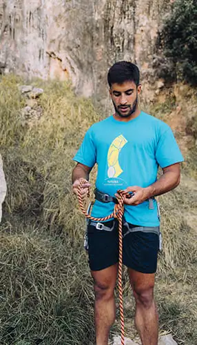 A volunteer securing a rope to rescue a young child, symbolizing compassion and the life-changing impact of every donation.